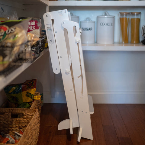 The Learn N Fold Learning Tower Toddler Tower is folded up and stored in the kitchen pantry.