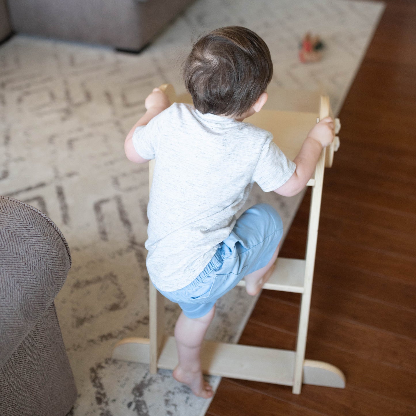 A young boy is climbing the stairs of the 2-in-1 Folding Learn N Slide.