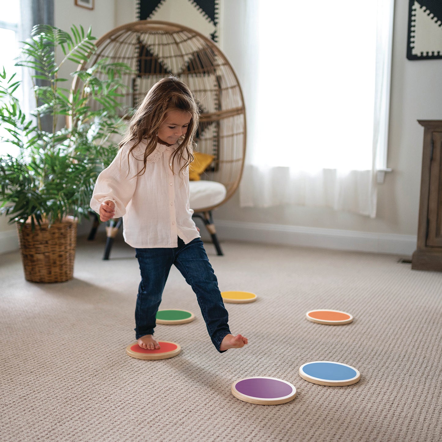 A young girl is walking on the Color Stepping Stones.